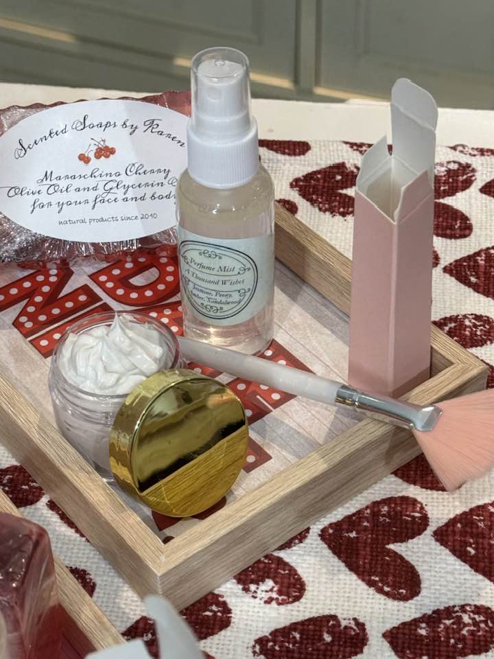 A Thousand Wishes perfume and hydrating Mist. Face Mask with brush. Lip Balm. Maraschino Cherry olive oil and glycerin soap. On a wooden tray of your choice.